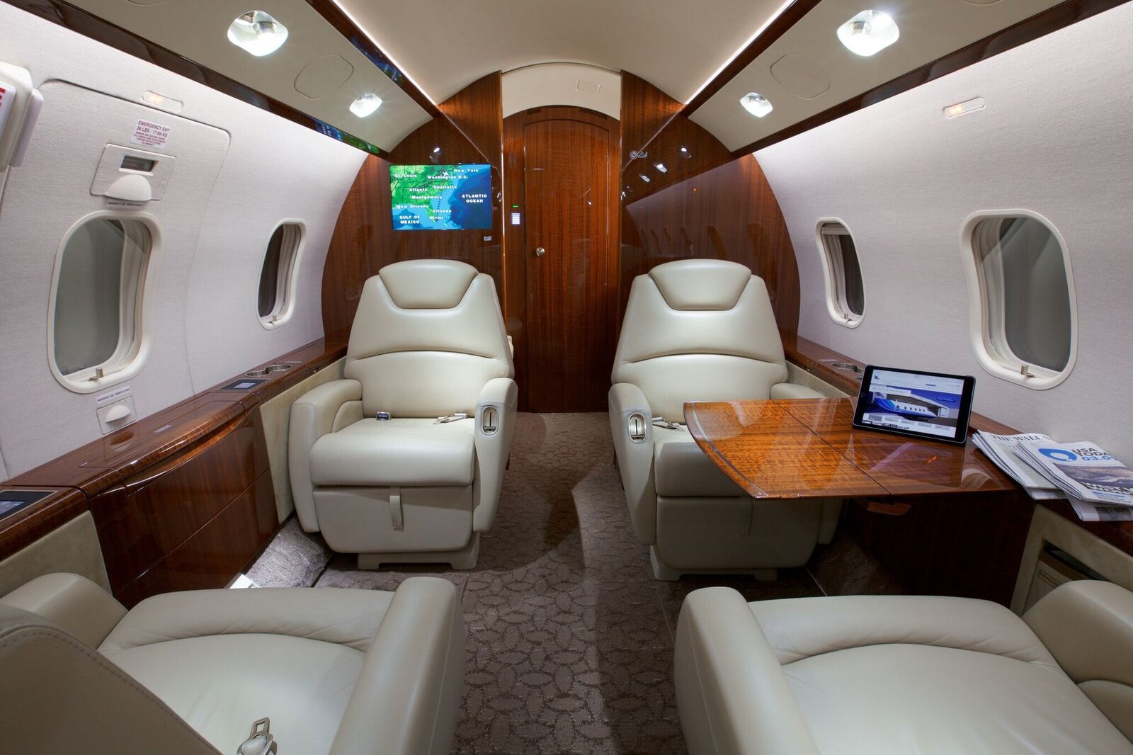 Challenger 300 cabin area with reclining seats and table